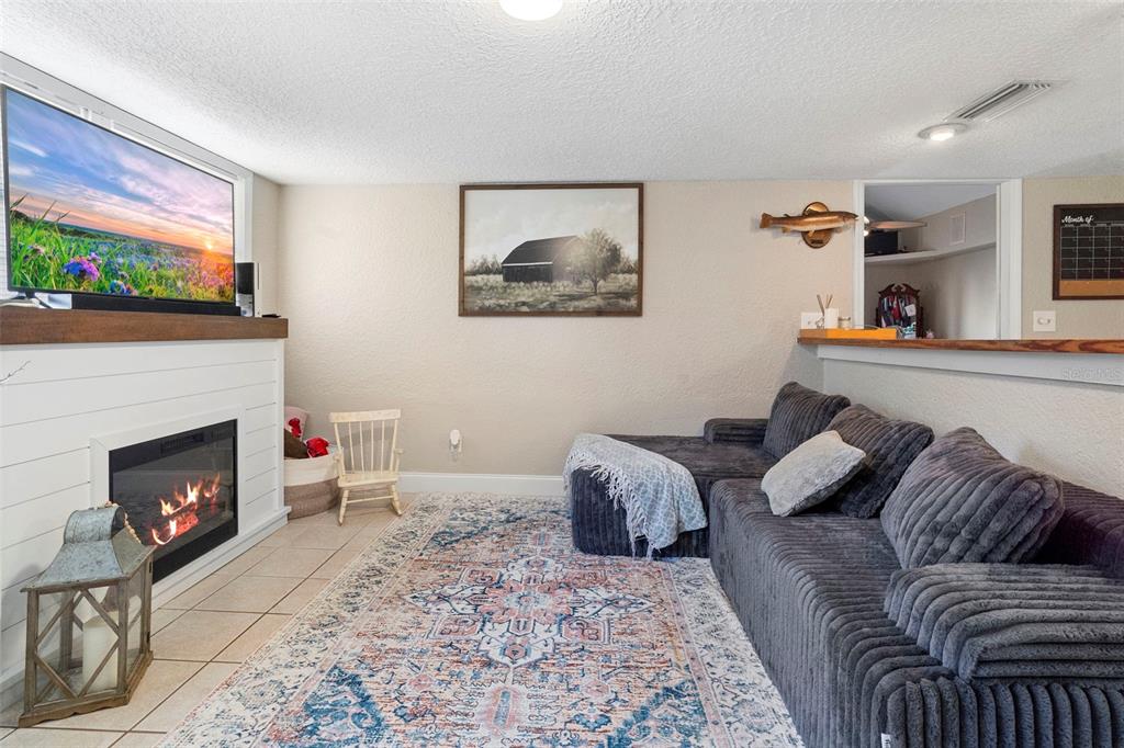 3080 Ragis Road Edgewater, FL 32132 - Photo 72 of 86 a living room with furniture and a fireplace