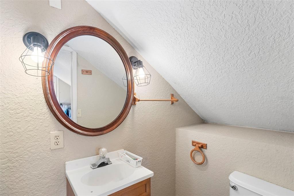 3080 Ragis Road Edgewater, FL 32132 - Photo 78 of 86 a close view of light fixtures and a mirror on a bathroom