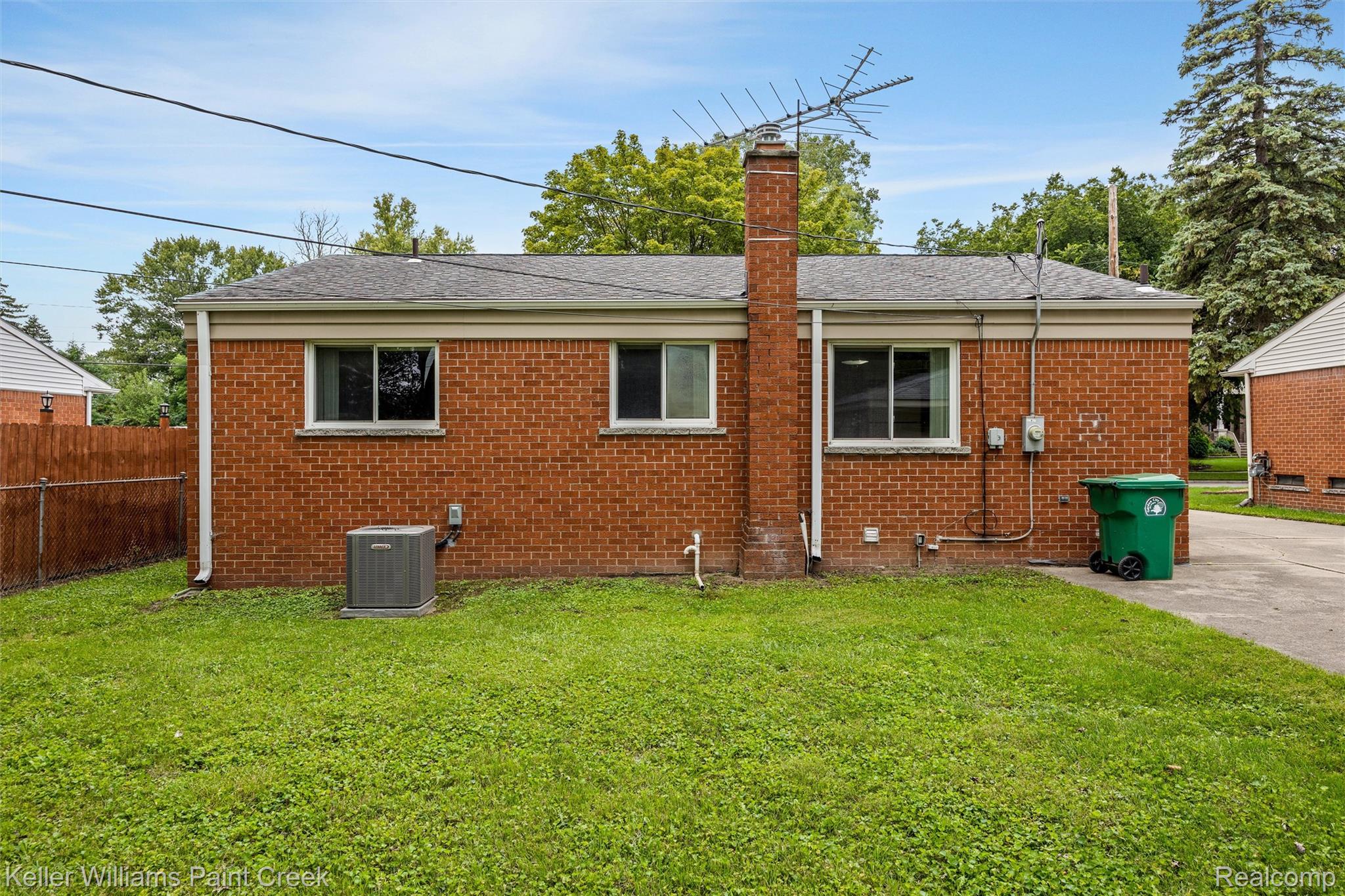 1766 Henry Ruff Road Garden City, MI 48135 - Photo 28 of 36 Brick exterior with a gabled roof, a chimney, and a concrete driveway