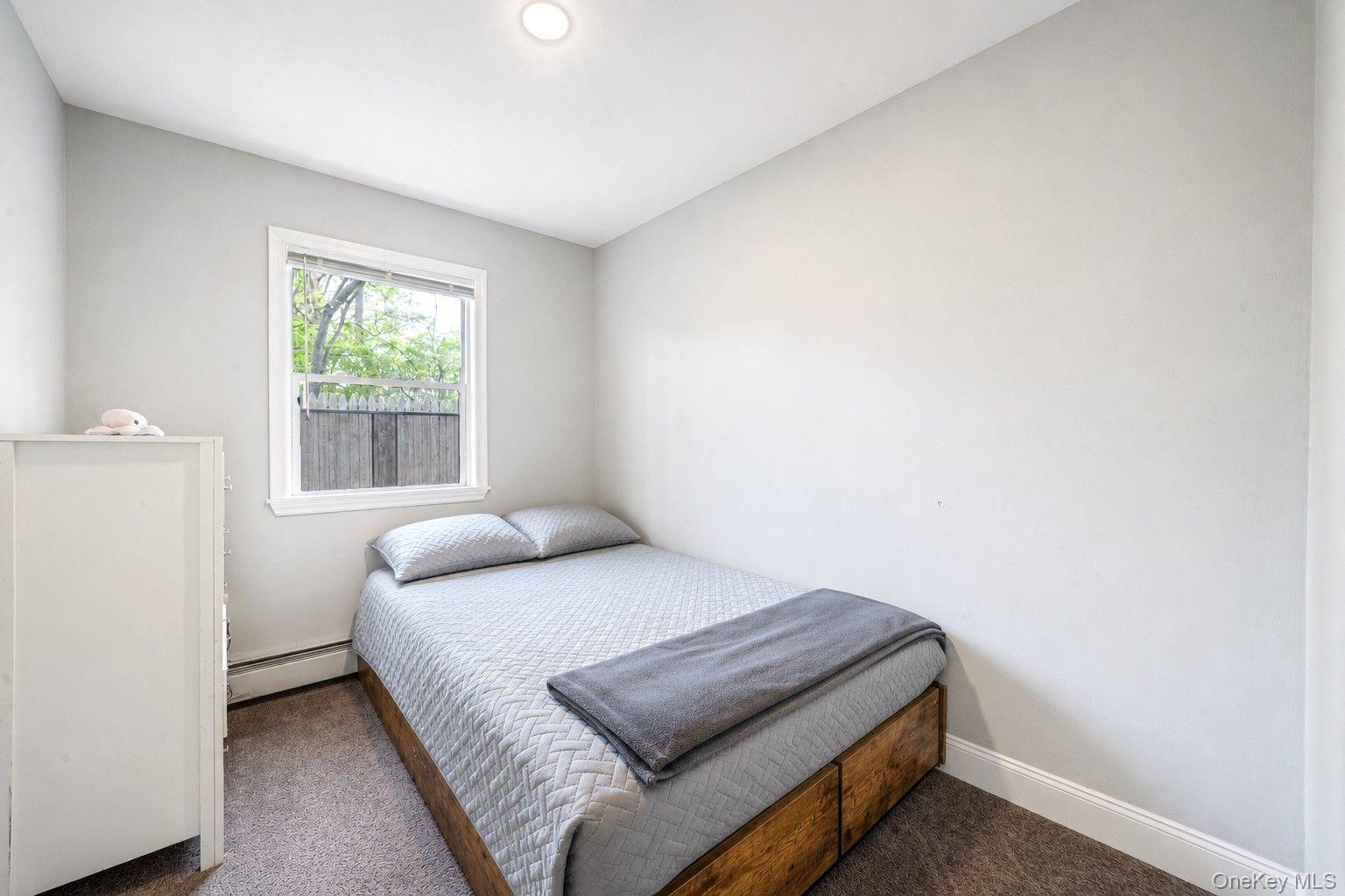 332 Commack Road Shirley, NY 11967 - Photo 18 of 25 a bedroom with a bed and a window