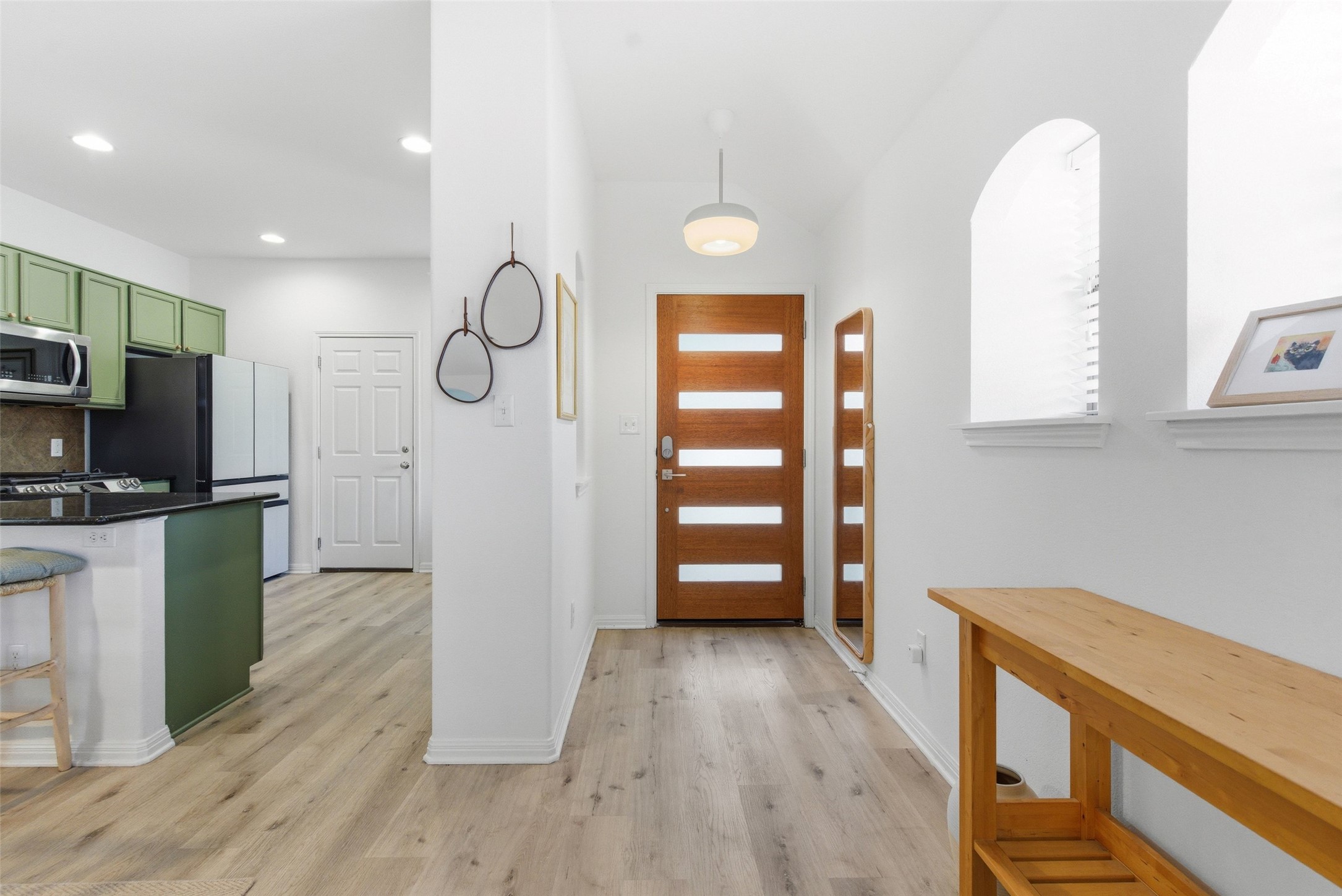 2513 Winchell Lane Austin, TX 78725 - Photo 2 of 23 a view of a kitchen with a sink wooden floor and cabinets