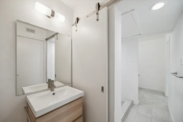 a bathroom with a sink a mirror and shower