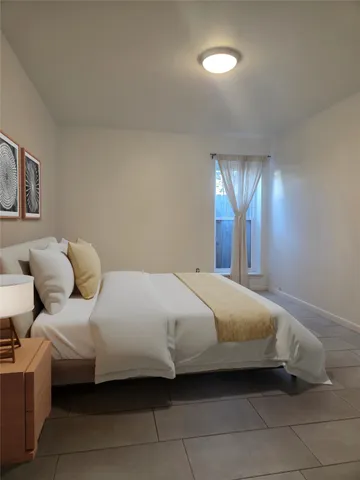 a bedroom with a bed and window