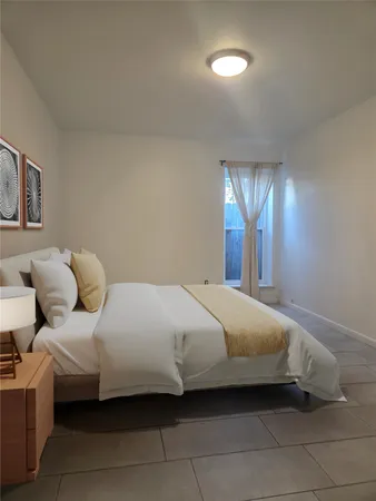 a bedroom with a bed and window