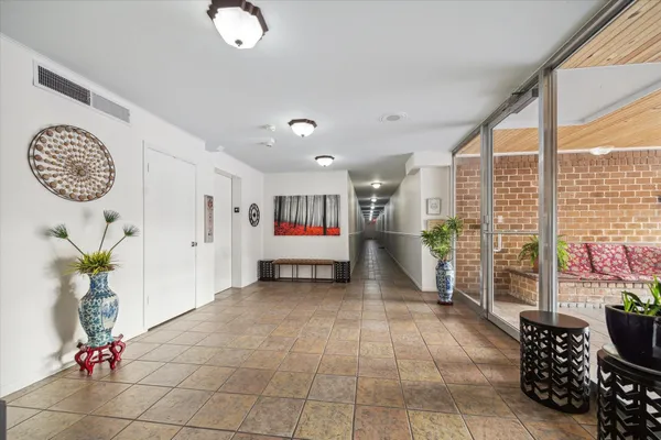 a living room with furniture and a floor to ceiling window