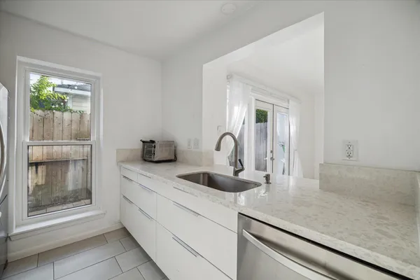 a kitchen with a sink and a mirror