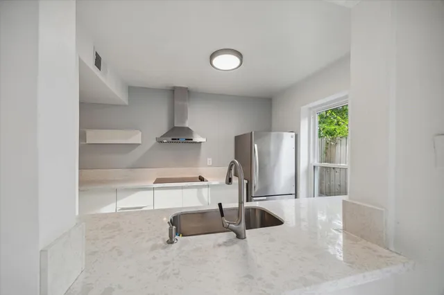 a kitchen with stainless steel appliances a refrigerator and a sink
