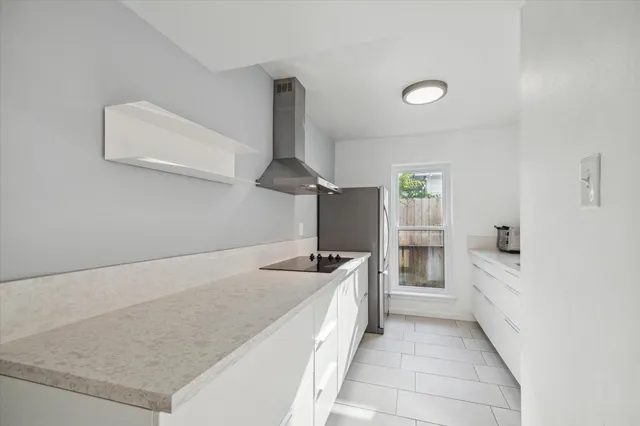 a kitchen with granite countertop a sink and stove