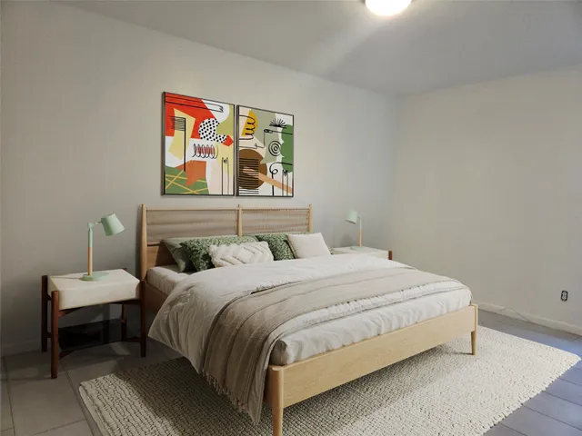 a bedroom with a bed and painting on the wall