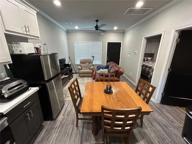 a dining room with furniture and wooden floor