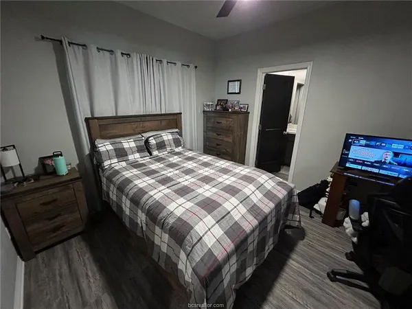 a bedroom with a bed and a mirror