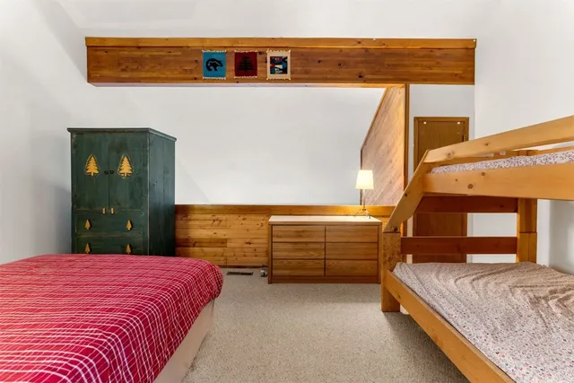 a bedroom with a bed and lamp