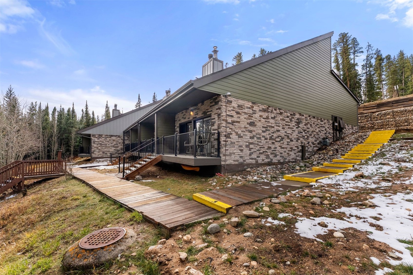 10500 Ryan Gulch Road, Unit J106 Silverthorne, CO 80498 - Photo 19 of 22 a view of a house with a yard and sitting area
