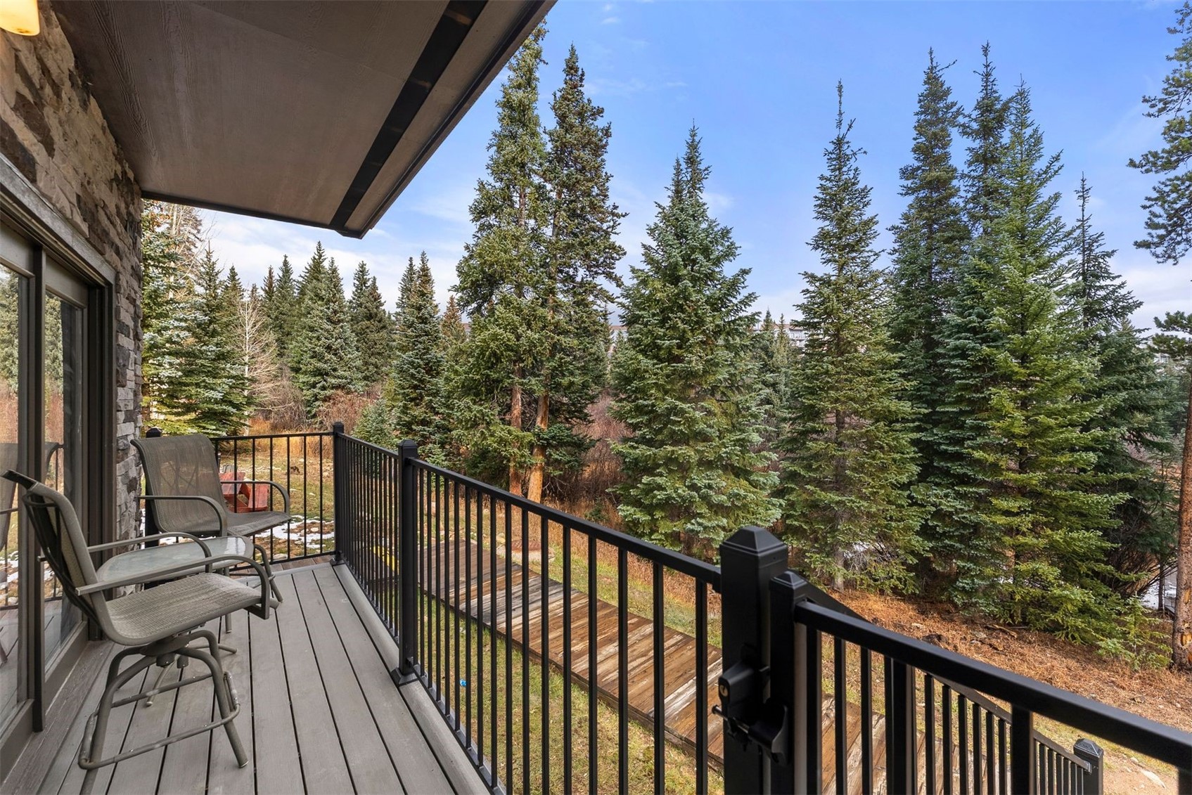 10500 Ryan Gulch Road, Unit J106 Silverthorne, CO 80498 - Photo 20 of 22 a view of a balcony with wooden floor and outdoor seating