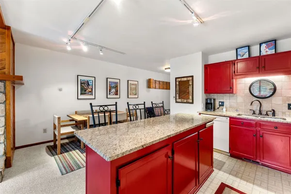 a kitchen with granite countertop a sink and cabinets