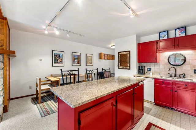 a kitchen with granite countertop a sink and cabinets