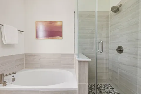 a bathroom with a bathtub and shower