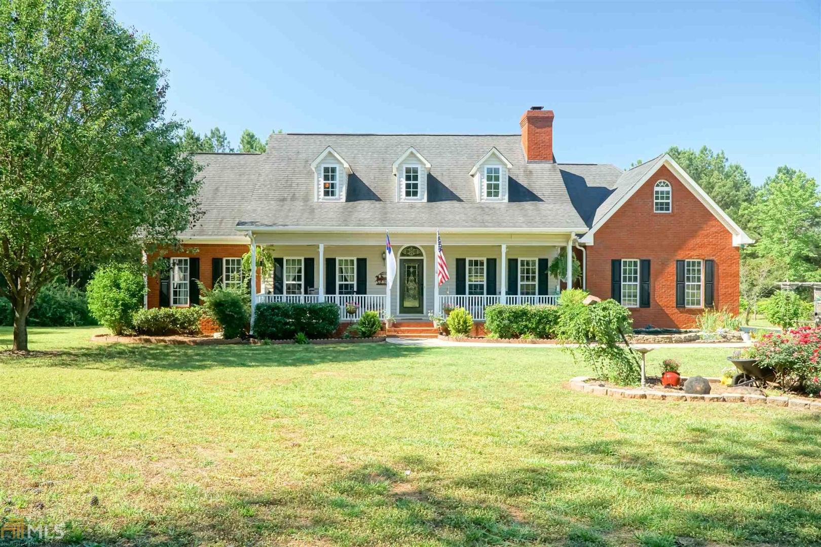 68 Apple Road Locust Grove, GA 30248 - Photo 1 of 1 a front view of a house with swimming pool having outdoor seating