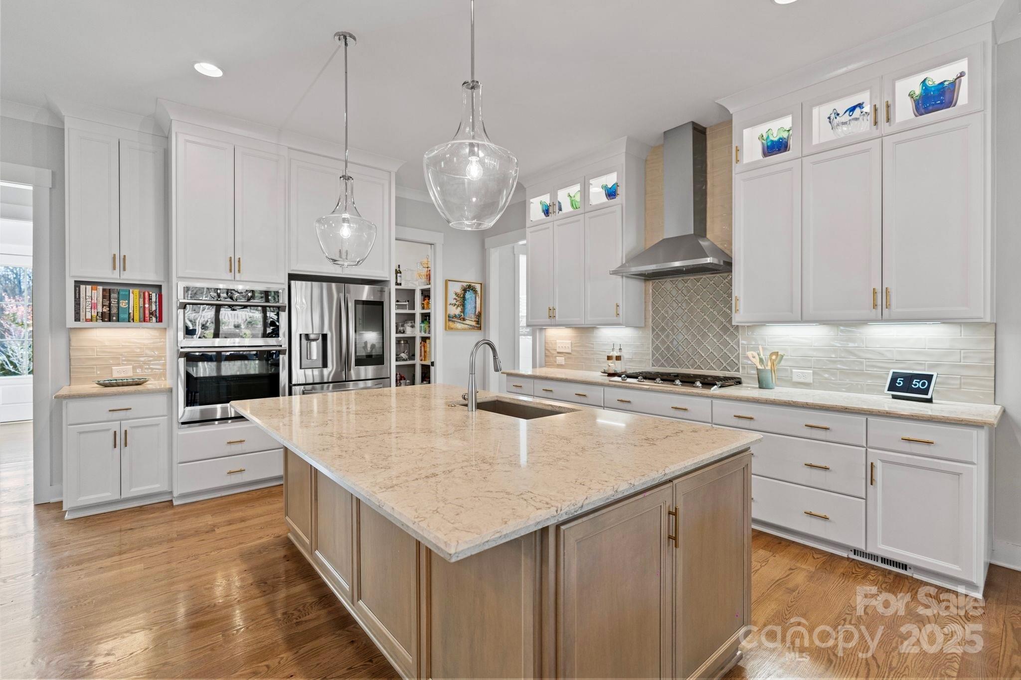 1502 Matthew McClure Circle Davidson, NC 28036 - Photo 12 of 48 a large kitchen with kitchen island a large island in it