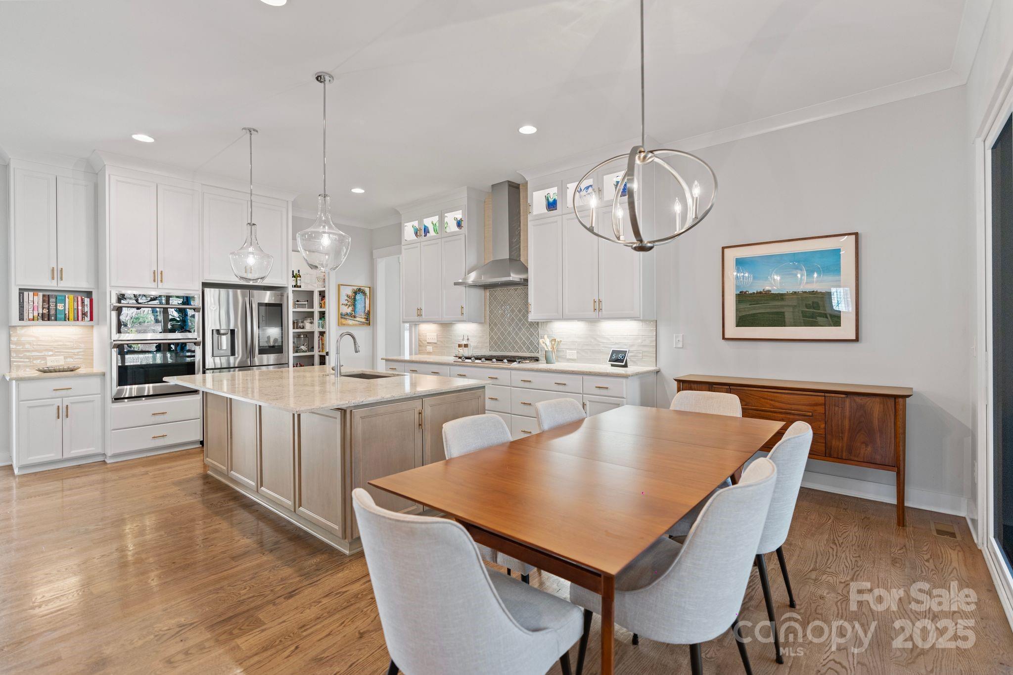 1502 Matthew McClure Circle Davidson, NC 28036 - Photo 15 of 48 a large kitchen with a table and chairs