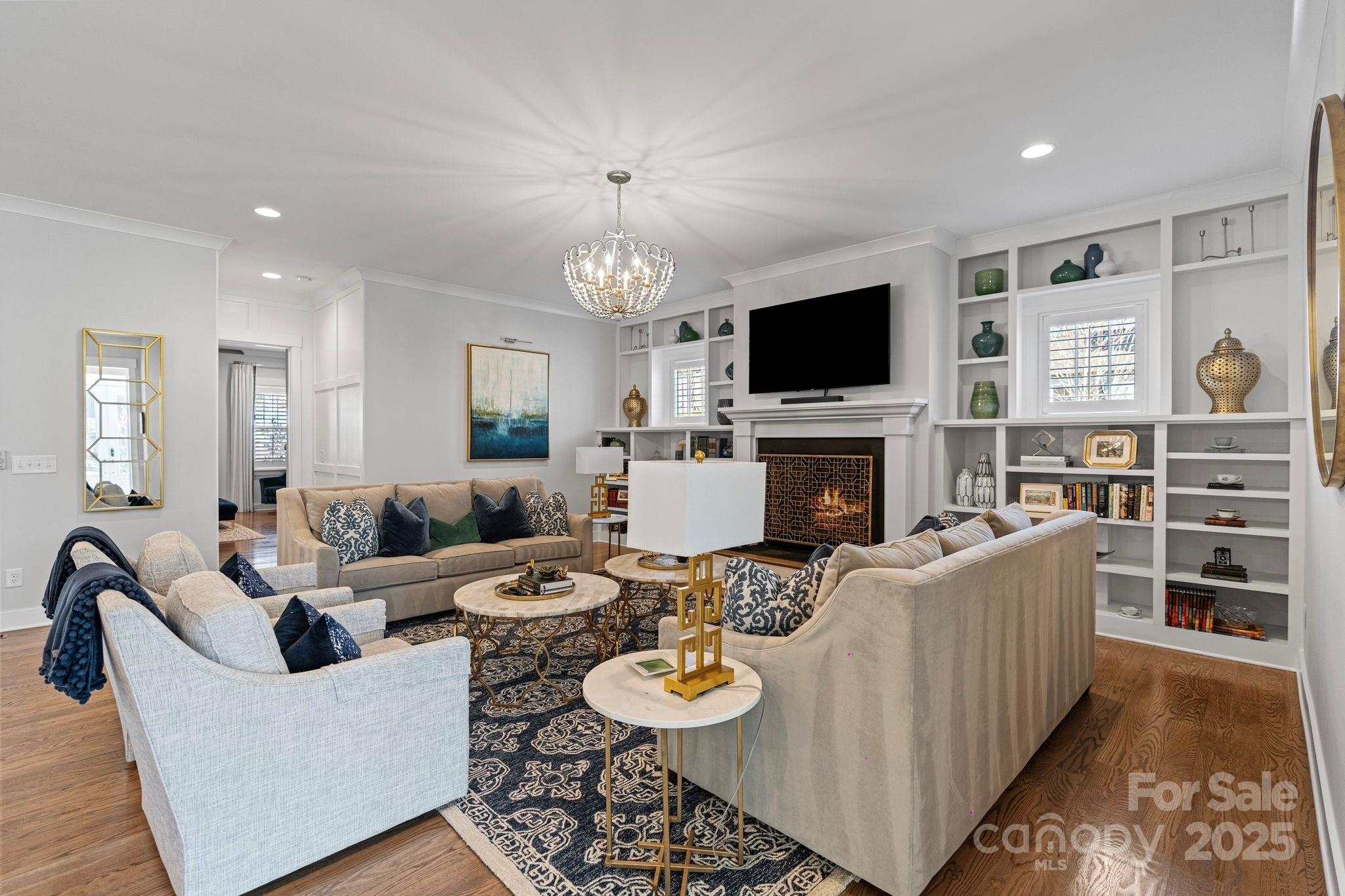 1502 Matthew McClure Circle Davidson, NC 28036 - Photo 8 of 48 a living room with furniture a flat screen tv and a fireplace