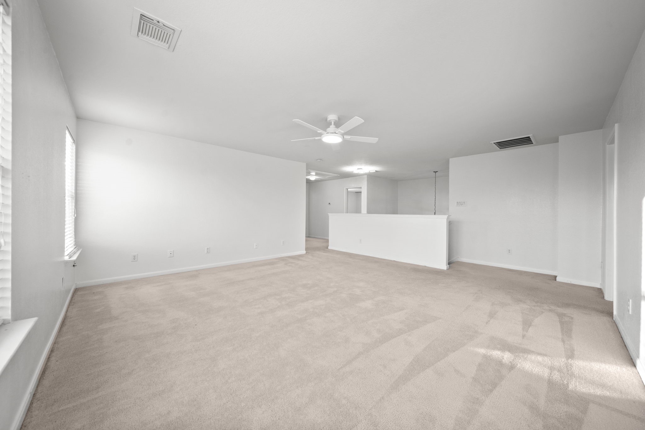 6323 Channelbrook Lane Spring, TX 77379 - Photo 16 of 24 a view of a big room with chandelier fan and windows