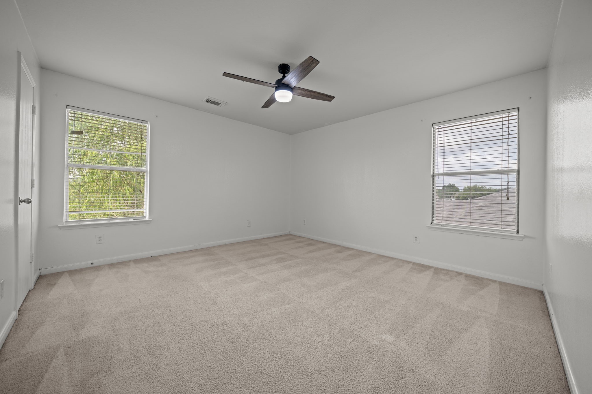 6323 Channelbrook Lane Spring, TX 77379 - Photo 20 of 24 an empty room with windows and fan