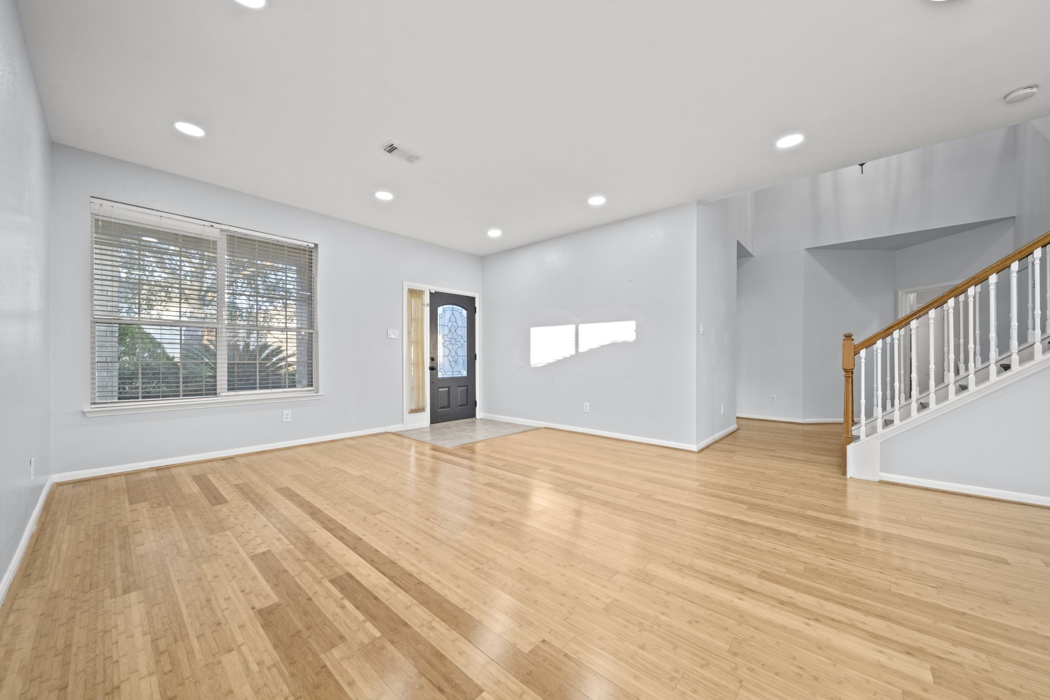 6323 Channelbrook Lane Spring, TX 77379 - Photo 2 of 24 a view of an empty room with wooden floor and a window