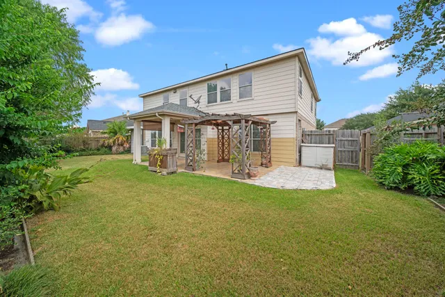a view of a house with a yard and sitting area