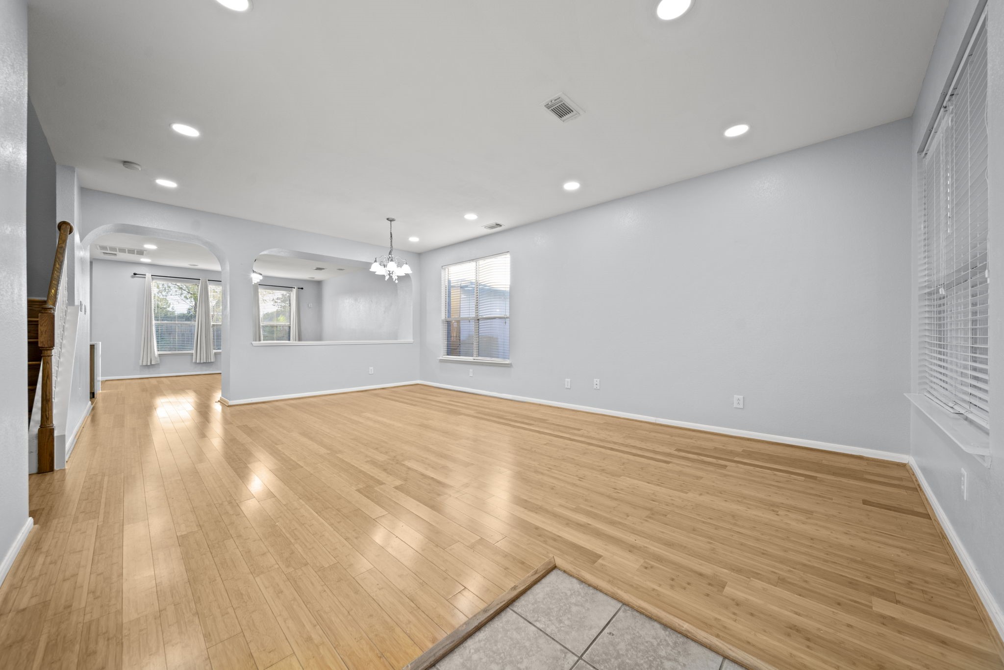 6323 Channelbrook Lane Spring, TX 77379 - Photo 3 of 24 a view of an empty room with wooden floor and a kitchen