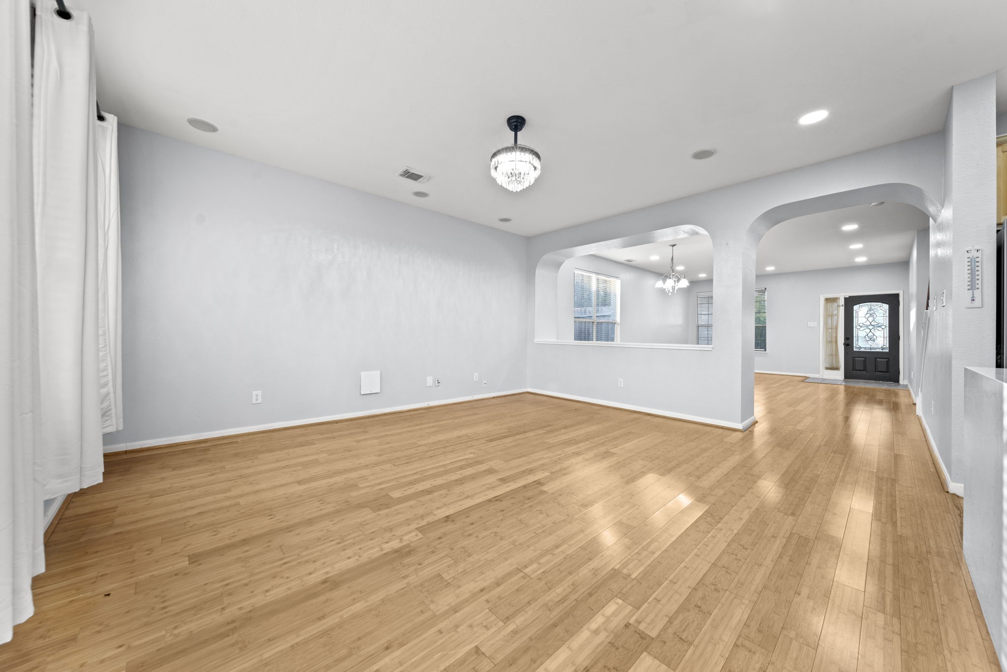 6323 Channelbrook Lane Spring, TX 77379 - Photo 4 of 24 a view of an empty room and window and wooden floor