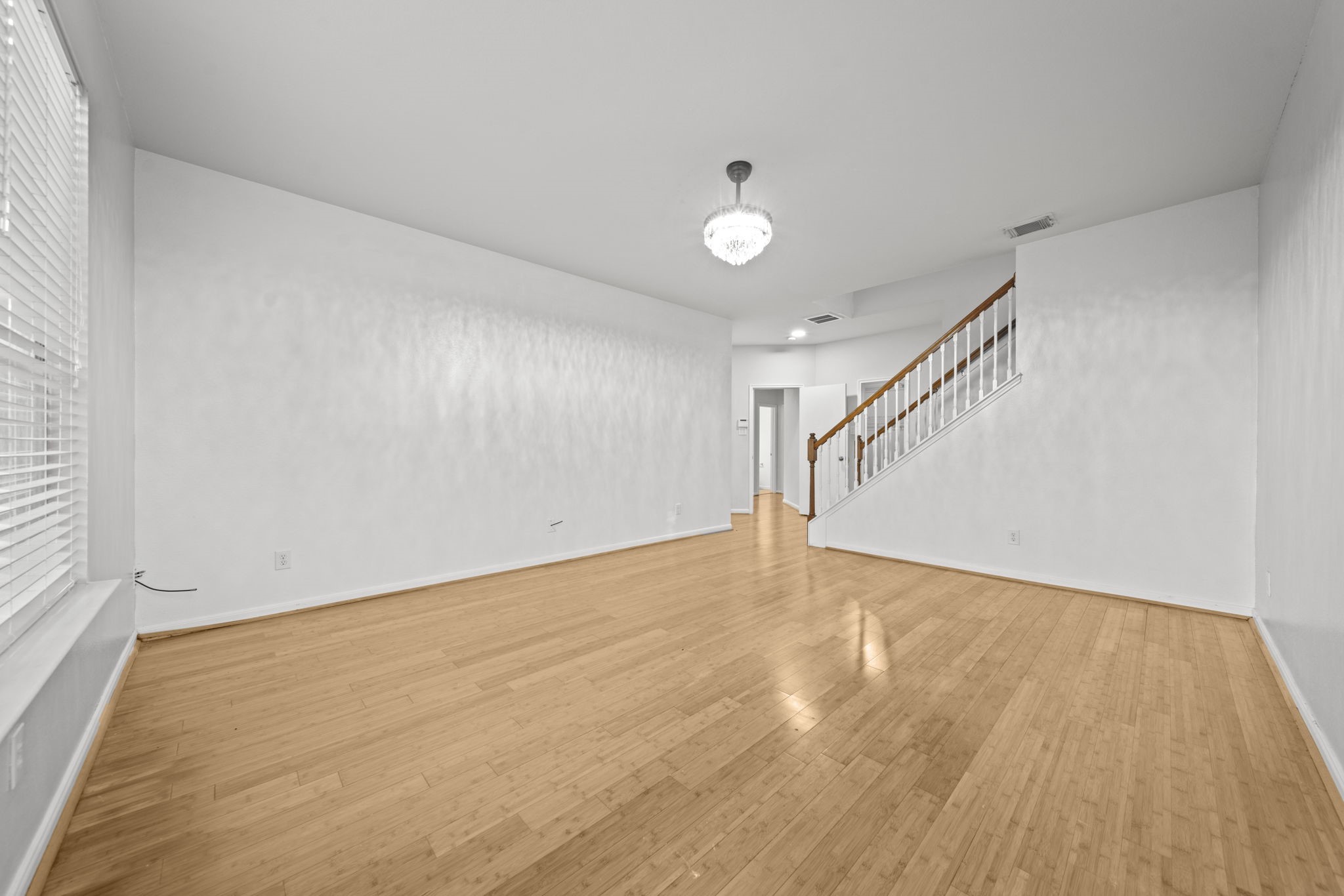 6323 Channelbrook Lane Spring, TX 77379 - Photo 5 of 24 a view of an empty room with wooden floor and stairs