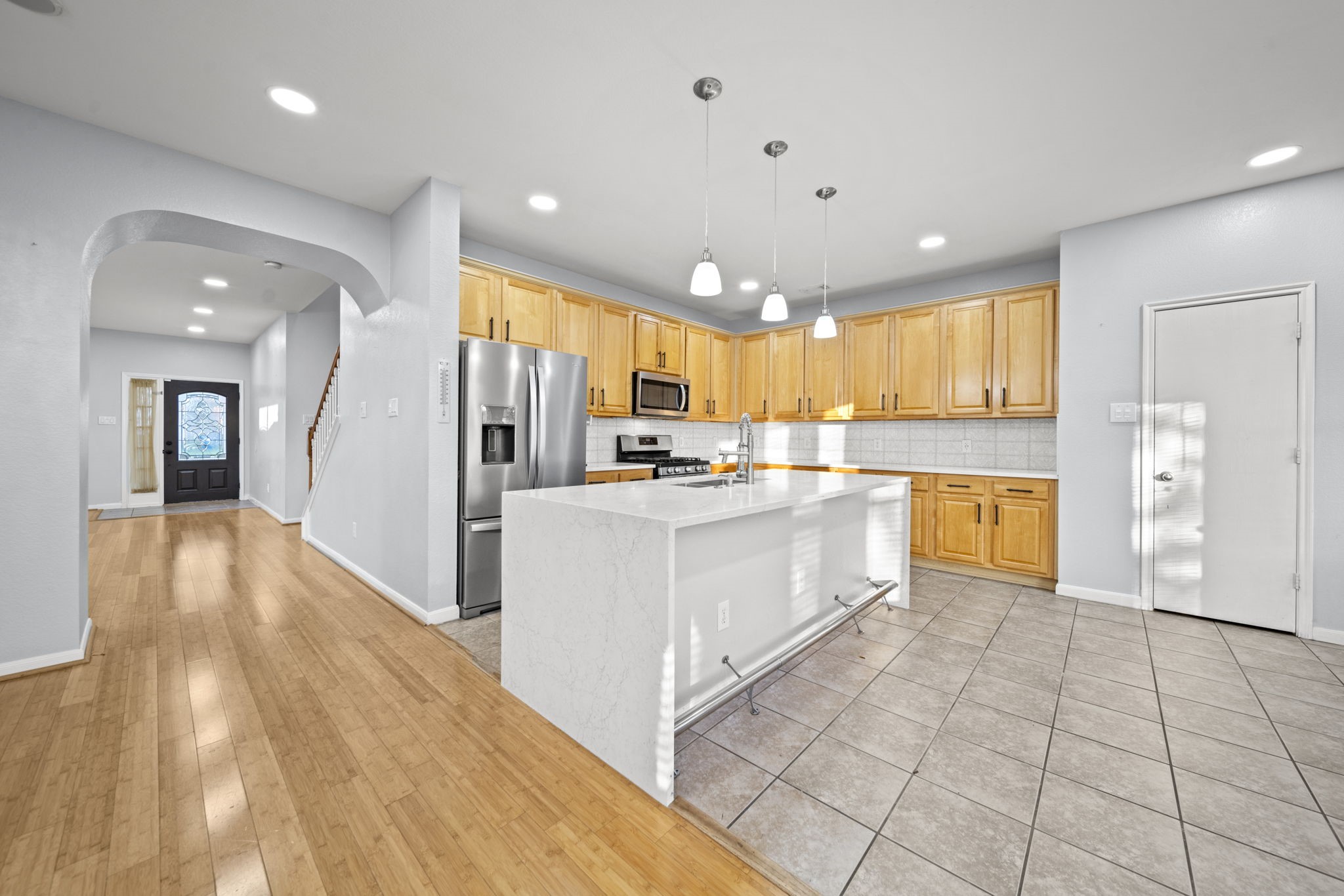 6323 Channelbrook Lane Spring, TX 77379 - Photo 6 of 24 a large white kitchen with a refrigerator a stove and a sink