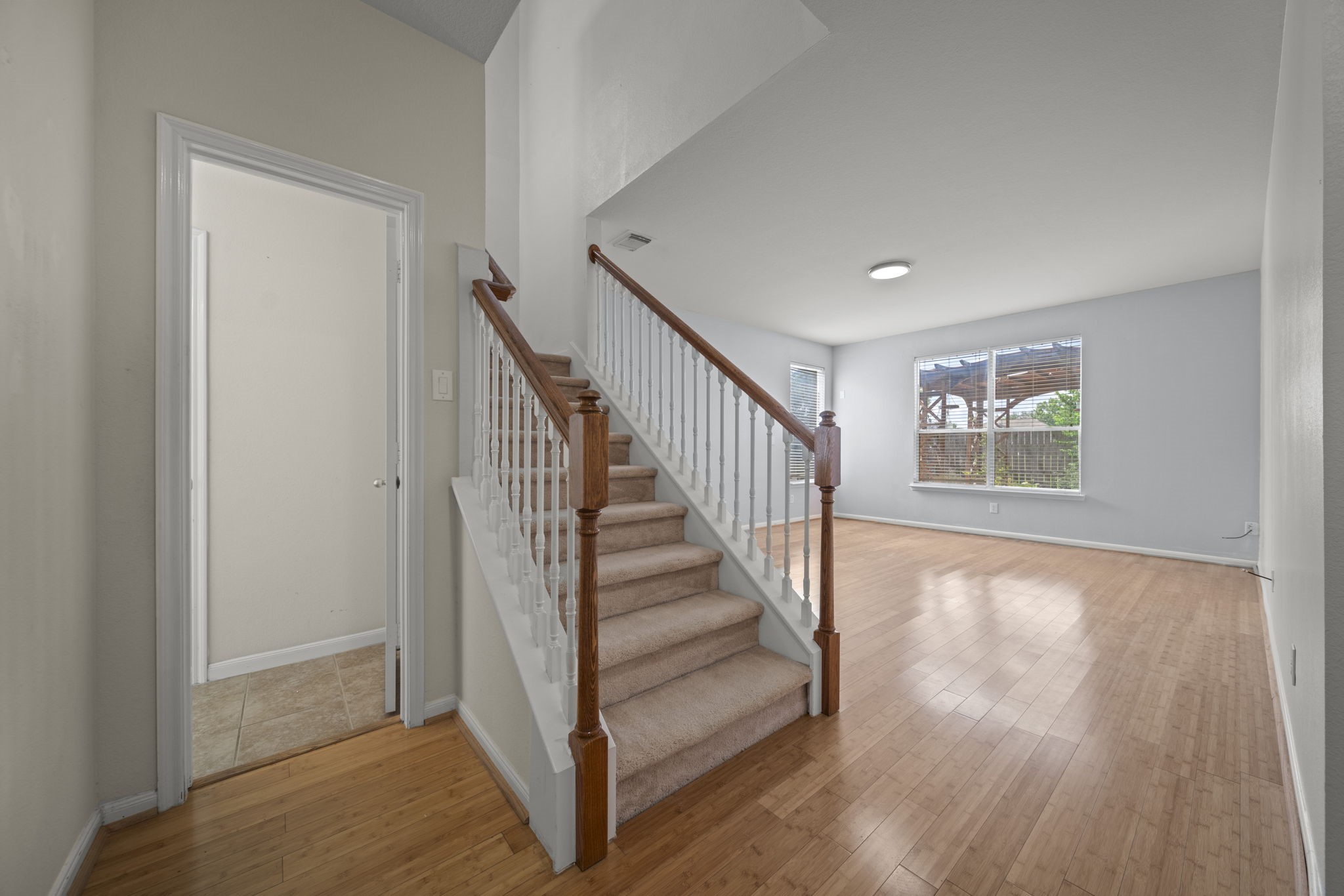 6323 Channelbrook Lane Spring, TX 77379 - Photo 8 of 24 a view of an entryway with wooden floor and stairs