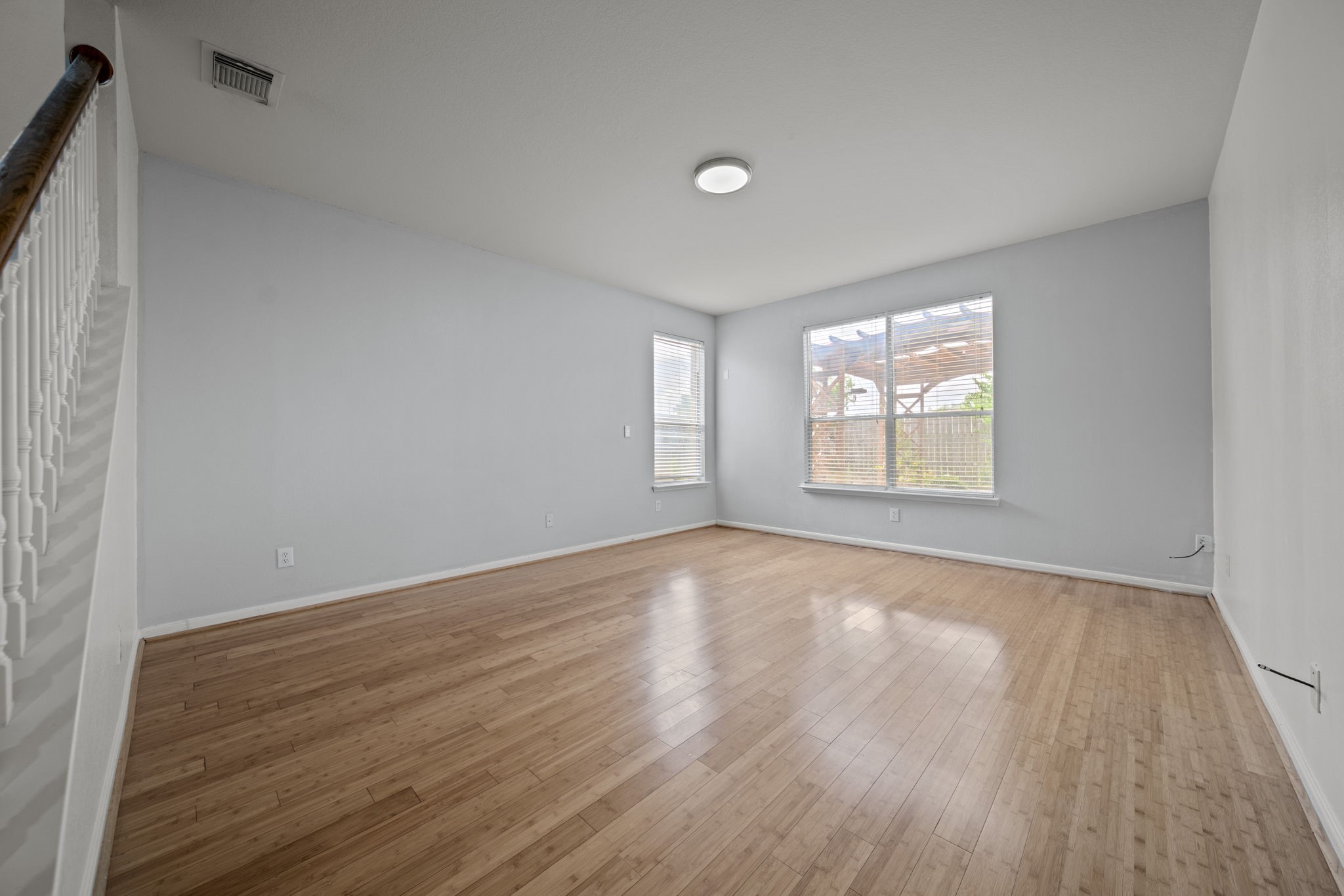6323 Channelbrook Lane Spring, TX 77379 - Photo 9 of 24 an empty room with wooden floor and windows