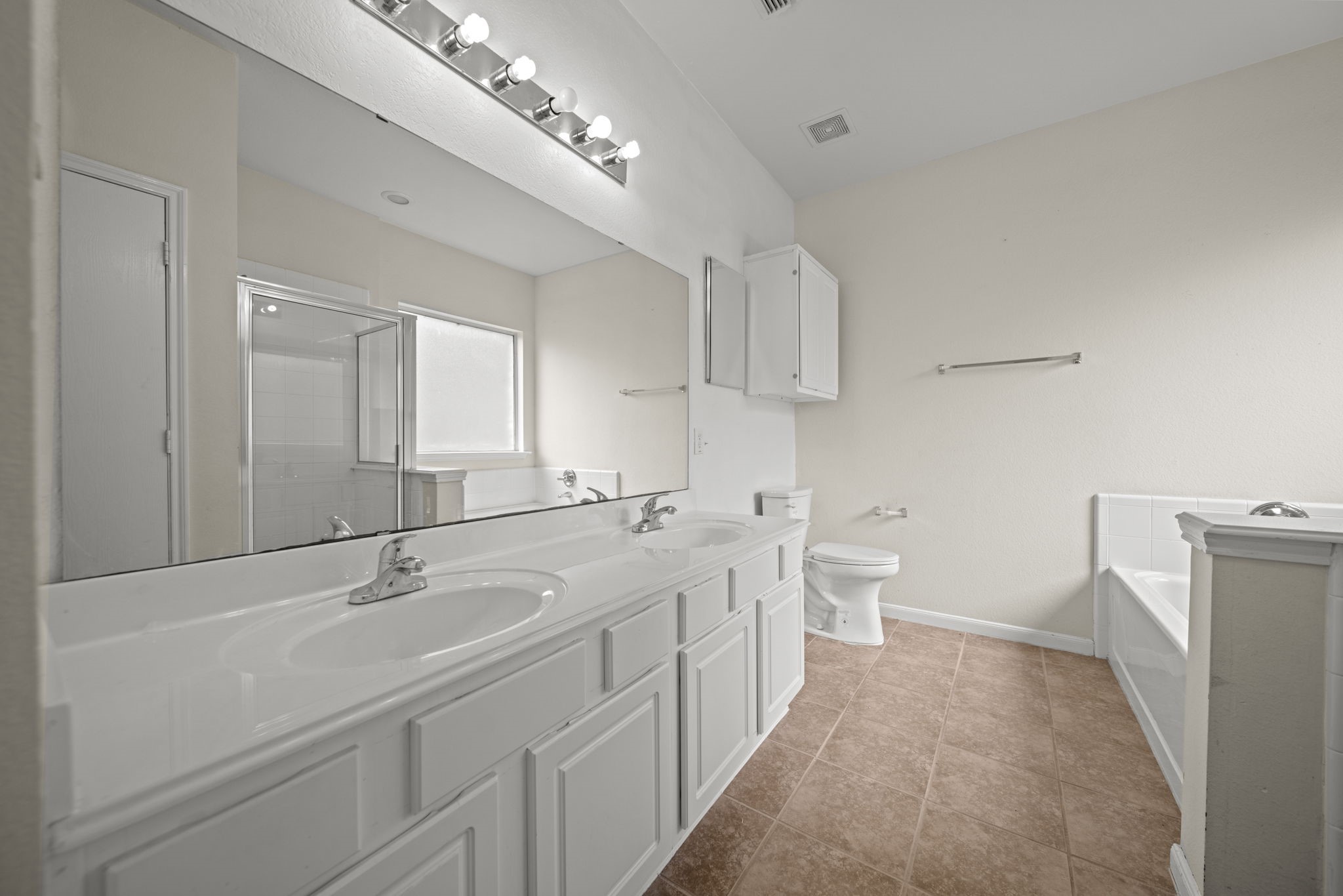 6323 Channelbrook Lane Spring, TX 77379 - Photo 10 of 24 a bathroom with a double vanity sink mirror and toilet