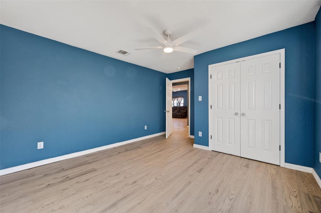 603 East Willingham Street Cleburne, TX 76031 - Photo 15 of 25 a view of an empty room with wooden floor