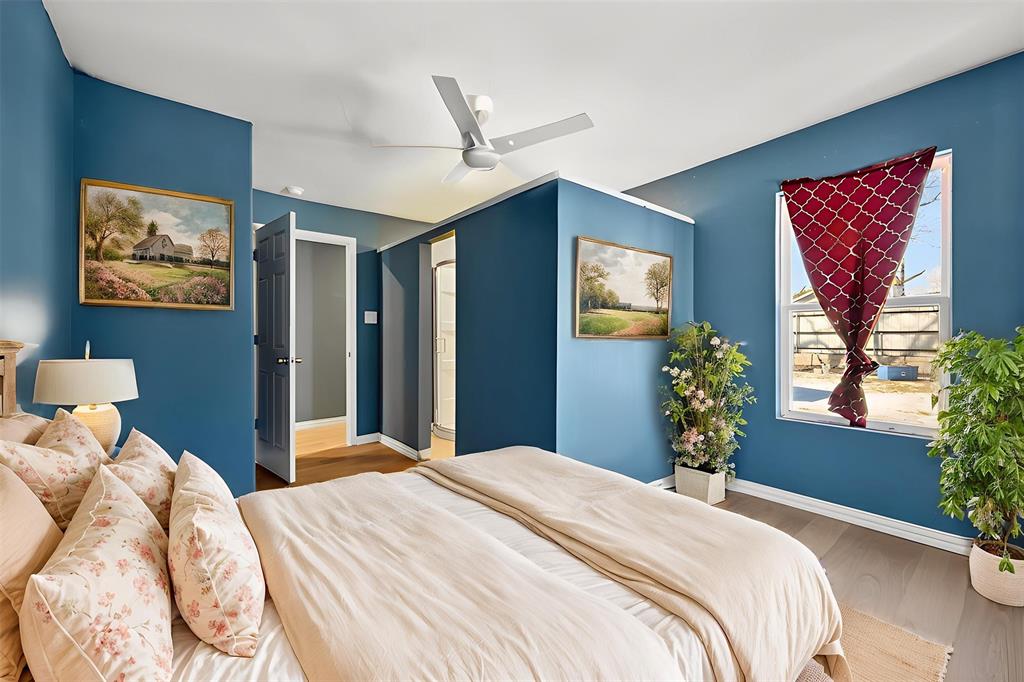 603 East Willingham Street Cleburne, TX 76031 - Photo 19 of 25 a bedroom with a bed and a chandelier