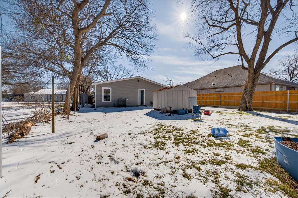 603 East Willingham Street Cleburne, TX 76031 - Photo 21 of 25 a front view of a house with a yard covered in snow