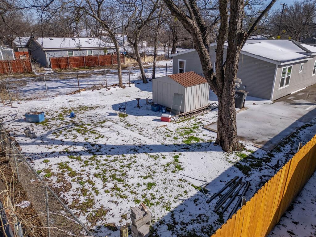 603 East Willingham Street Cleburne, TX 76031 - Photo 22 of 25 a tree in front of a house with a yard