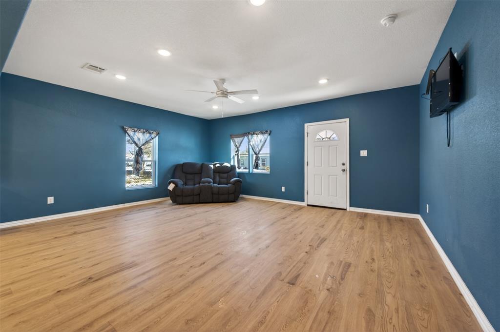 603 East Willingham Street Cleburne, TX 76031 - Photo 6 of 25 a view of livingroom with furniture and wooden floor