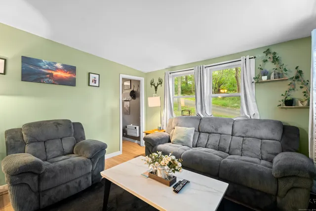 a living room with furniture couches and a large window