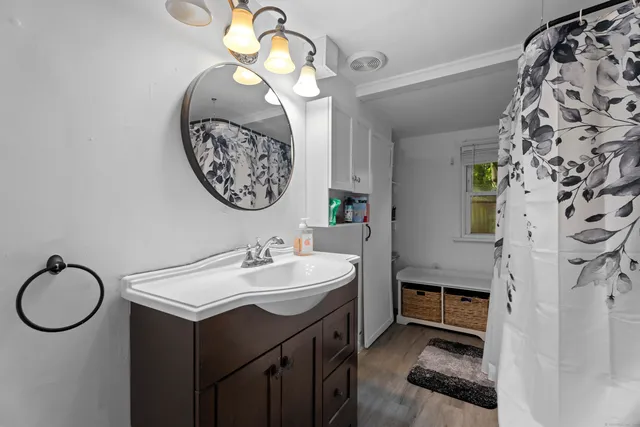 a bathroom with a sink a mirror and a shower