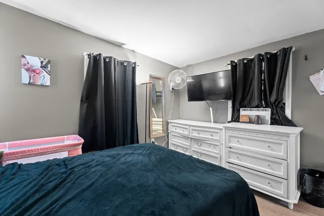 a bedroom with a bed and a flat screen tv