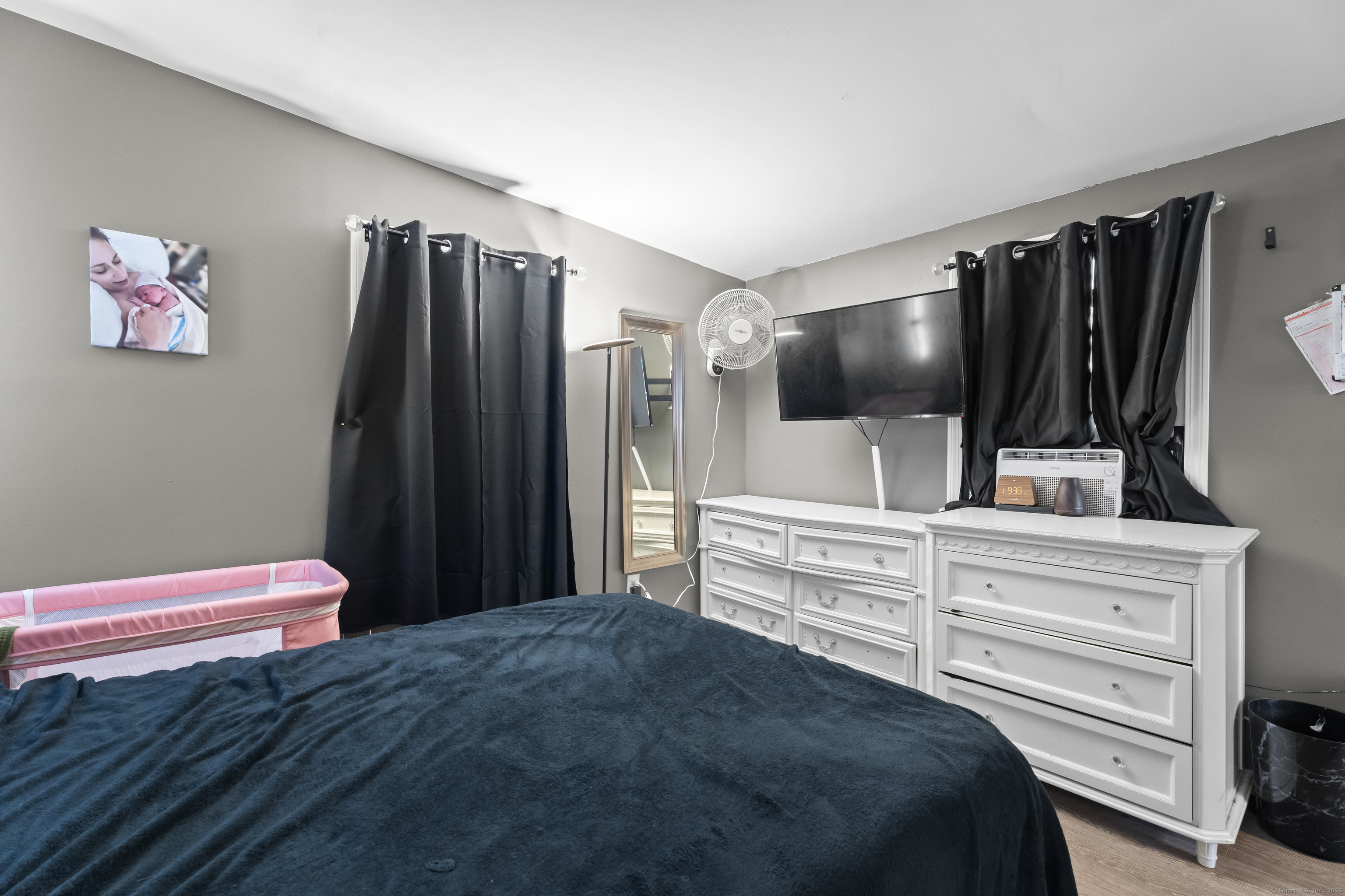 133 West Main Street, Unit MV1 Clinton, CT 06413 - Photo 18 of 36 a bedroom with a bed and a flat screen tv