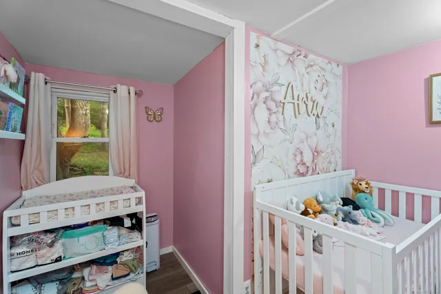 a bedroom with a bed and a dresser in it