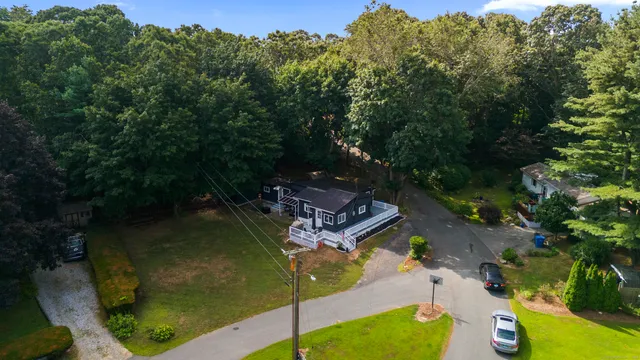 an aerial view of a house with a yard basket ball court and outdoor seating
