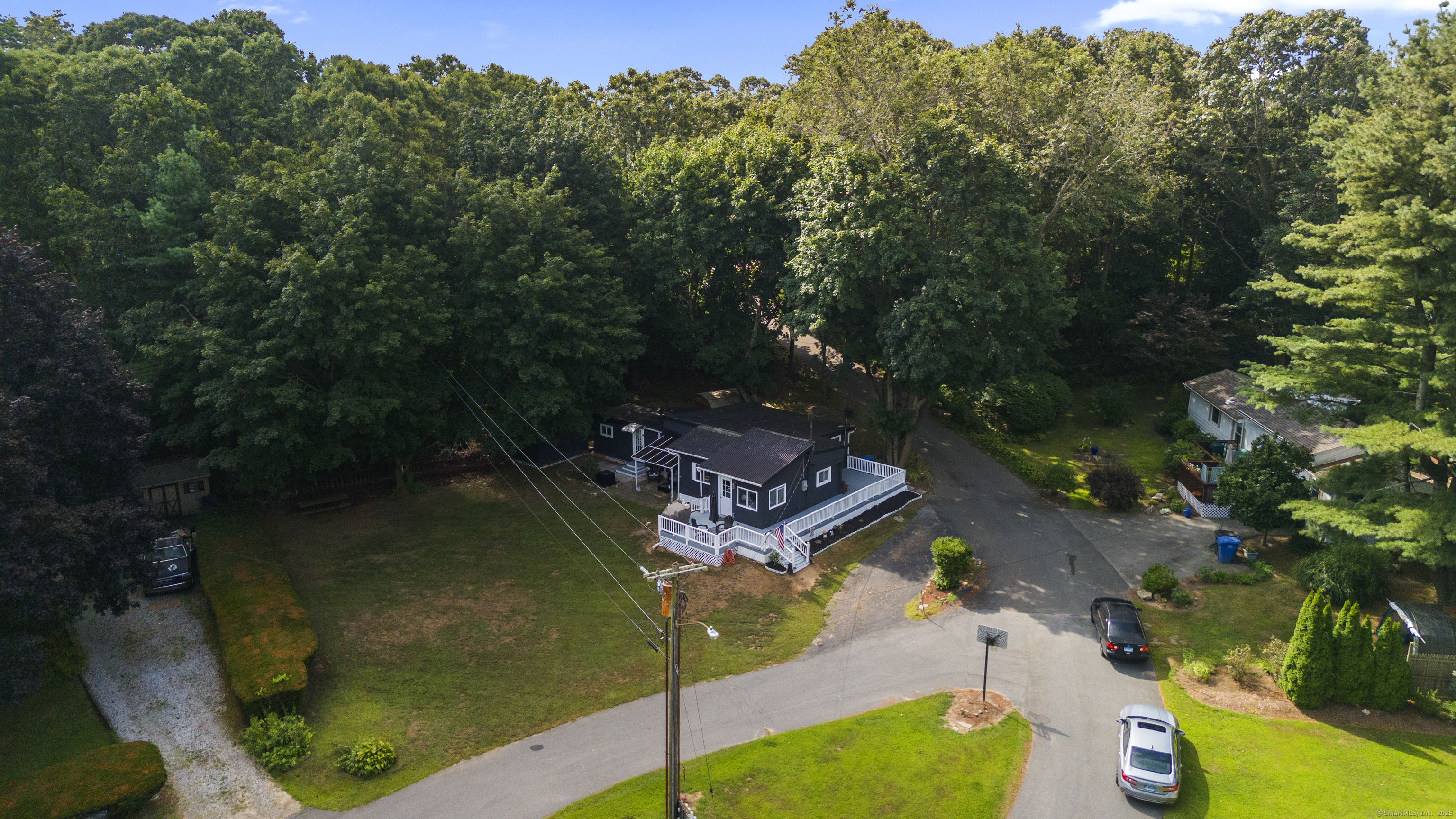 133 West Main Street, Unit MV1 Clinton, CT 06413 - Photo 2 of 36 an aerial view of a house with a yard basket ball court and outdoor seating