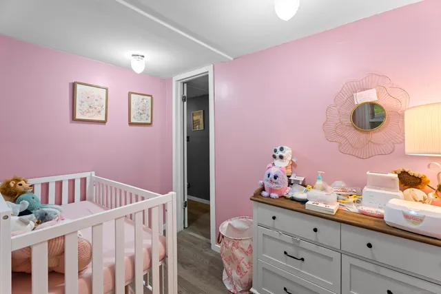 a bedroom with furniture and a baby crib