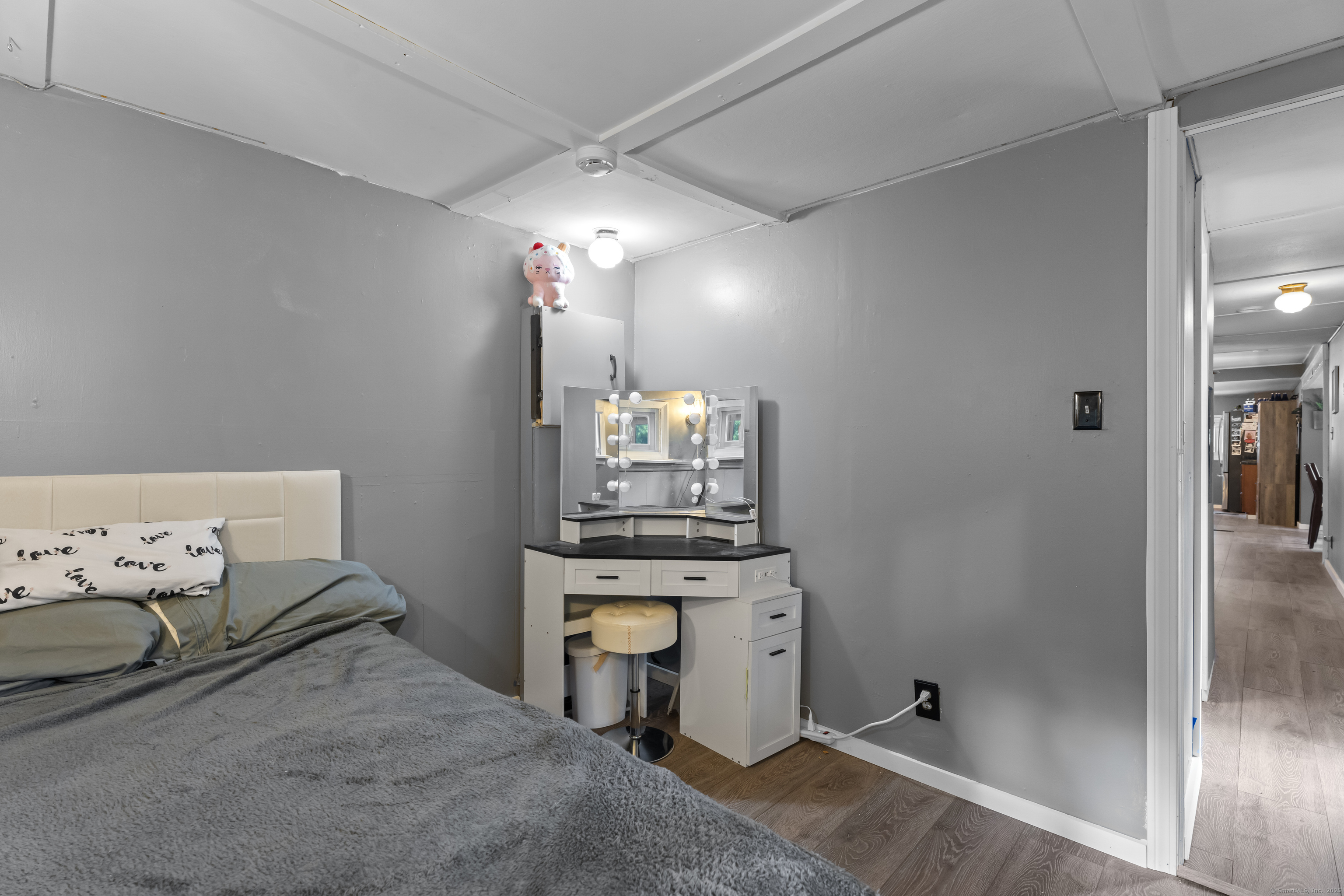 133 West Main Street, Unit MV1 Clinton, CT 06413 - Photo 24 of 36 a room with kitchen island a chandelier furniture and a chandelier